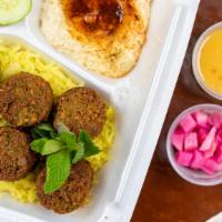 Falafel Plate · Six balls of fried falafel served with hummus, salad, pickles, tahini sauce, and pita bread.