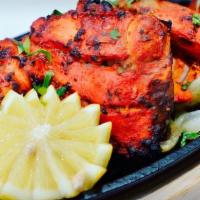 Chicken Tikka · Tender boneless pieces of chicken marinated and cooked on skewers.