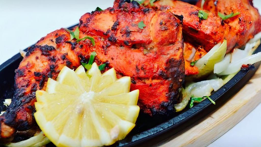 Chicken Tikka · Tender boneless pieces of chicken marinated and cooked on skewers.
