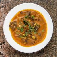 Goat Curry · Gluten friendly. Goat bone-in simmered in tomato and onion gravy.
