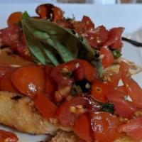 Bruschetta Pomodori · Grilled rustic Italian bread topped with marinated chopped tomato, garlic and fresh basil.