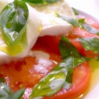 Mozzarella Caprese · Fresh buffalo mozzarella, sliced sun-ripened tomato and basil with extra virgin olive oil.