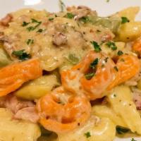 Tortellini Carbonara · Fresh tri-color tortellini in a sautéed garlic, pancetta bacon, white wine light cream carbo...