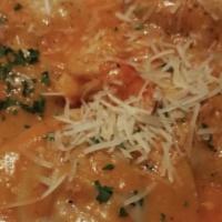 Ravioli Aragosta · Fresh ravioli filled with lobster meat and drizzled with a lobster bisque sauce with chunks ...