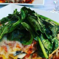 Lasagna Al Verdura · Baked layers of fresh lasagna sheets, a spinach, and artichoke medley, ricotta, and mozzarel...