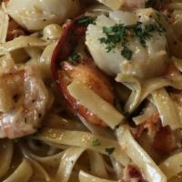 Fettuccine Oceano · Pan-roasted lobster meat, shrimp and scallops in a lemon cream sauce, tossed with fettuccine...