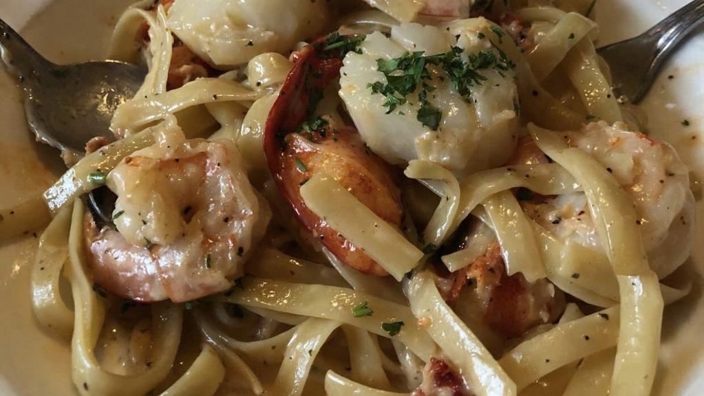 Fettuccine Oceano · Pan-roasted lobster meat, shrimp and scallops in a lemon cream sauce, tossed with fettuccine pasta.