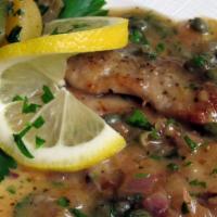 Vitello Piccata · Milk-fed veal scaloppine topped with a garlic, lemon-caper sauce, served with sautéed spinac...