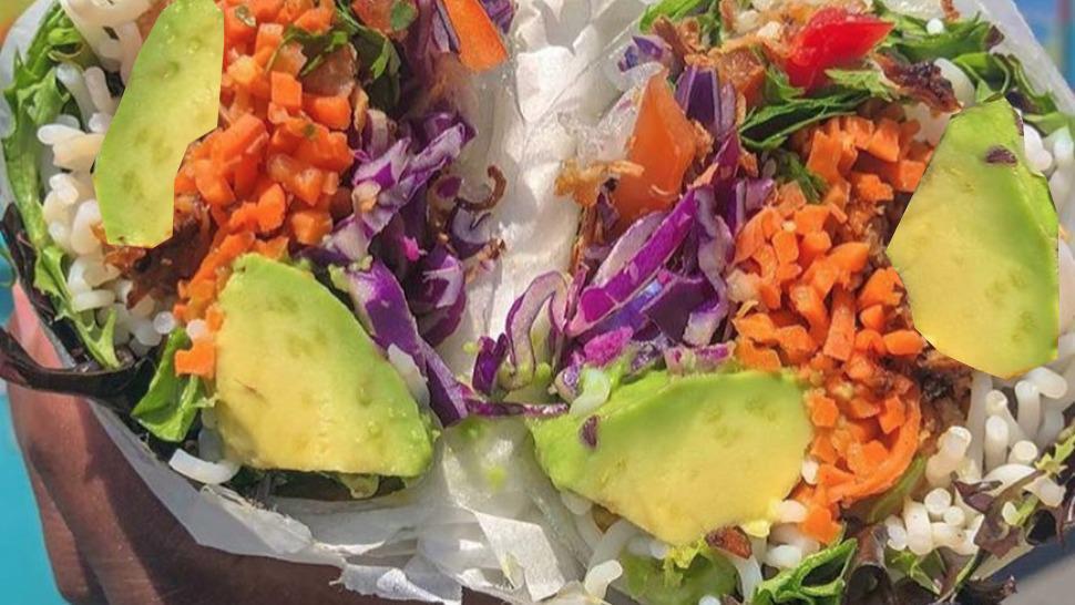 Avocado Fiesta Spurrito · Half avocado, spicy peanut sauce, brown rice, pineapple, lightly pickled carrot, peppers, cilantro, cabbage, mixed greens, crispy shallots, crushed tortilla chips. 
Gluten Free and Vegan.