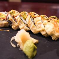 Golden Maki · Deep fried. Crispy salmon with avocado and crabmeat inside and a hint of unagi sauce. Topped...