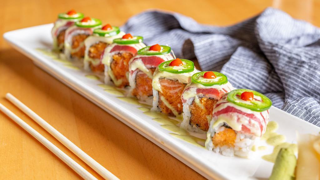 Kiss The Fire · Spicy salmon roll with jalapeno pepper, topped with white tuna and yellowfin tuna. Raw. Hot and spicy.