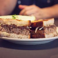Atomic Meatloaf Meltdown · house grilled meatloaf, jack cheese, red onion jam and inner beauty hot sauce on grilled sou...