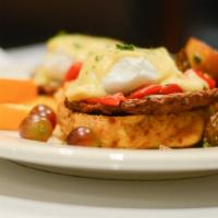 Western Benedict · Two poached eggs, chicken sausage, red peppers and onions on an cheddar biscuit, hollandaise.