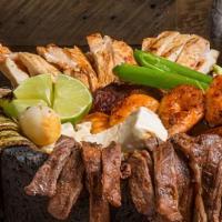 Molcajete · Combo of grilled steak, chicken, chorizo, shrimp, nopal, bell peppers and scallions, served ...