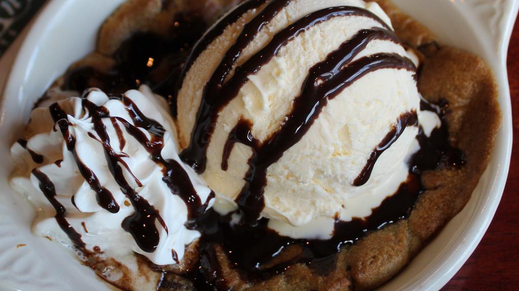 Chocolate Chip Cookie Dough Sundae · Freshly baked chocolate chip cookie topped with vanilla ice cream and chocolate sauce.