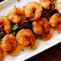 Bangin' Shrimp · Crispy shrimp with a spicy chili drizzle and a sweet chili aioli for dipping