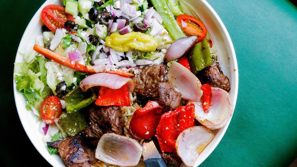Kabob Tips & Salad With Steak Tips · Mixed peppers and onions over rice pilaf with a tossed Greek salad