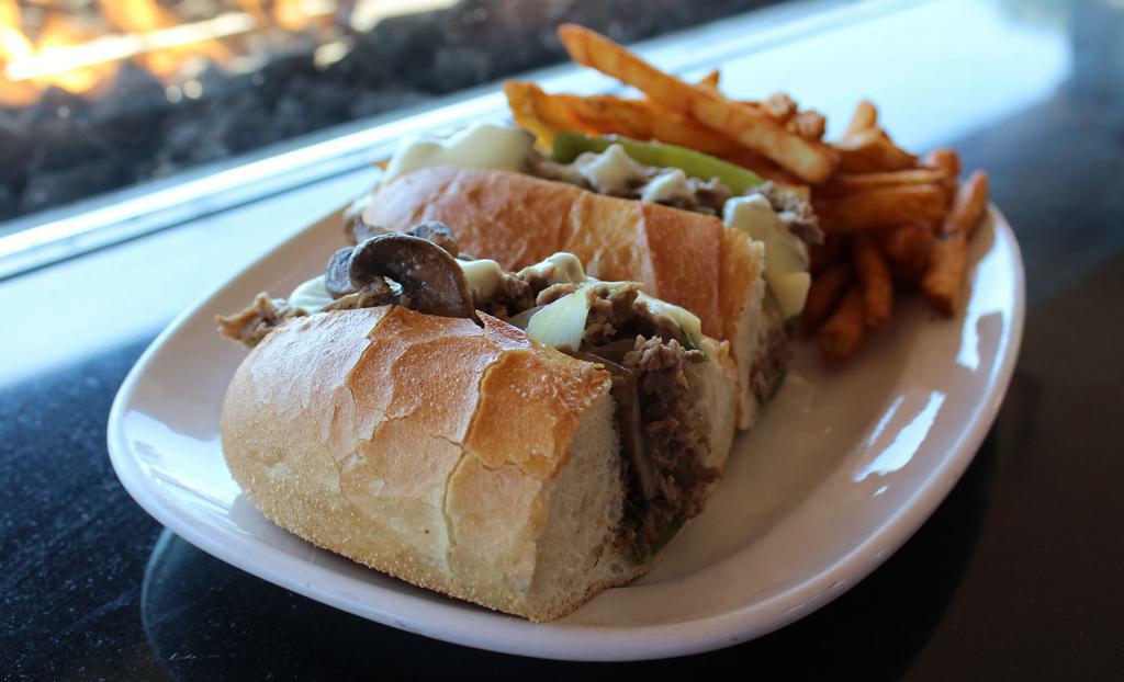 Philly Cheesesteak · Shaved rib-eye steak, American cheese, peppers, onions & mushrooms on a toasted roll.