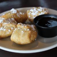 Fried Oreo Puffs (4) · Four (4) fried oreo puffs dusted with powdered sugar and served with chocolate sauce