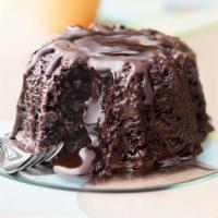 Molten Lava Chocolate Cake · Moist covered dark chocolate cake filled with warm dark chocolate truffle. Served with vanil...