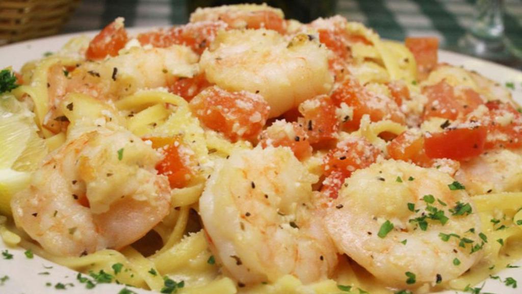 Shrimp Scampi · Tender Gulf shrimp Sautéed in a garlic white wine sauce seasoned with a blend of spices tossed with tomatoes and linguini