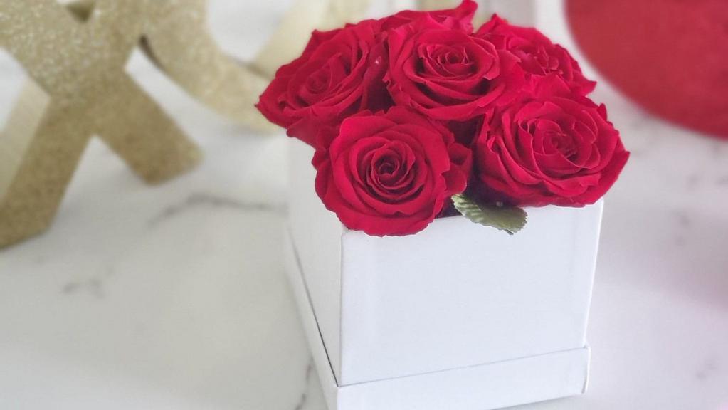 Small Square · This handmade bouquet boasts beautiful large buds of real roses accompanied by a few touches of green eucalyptus nestled in a modest white box. Delight that special someone in your life with a gift that combines beauty and luxury. Roses last a year or more.