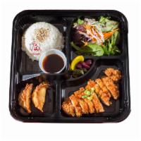 Chicken Katsu Bento Box · Panko breaded chicken cutlet, 2 pcs of fried gyoza, green salad with ginger dressing, steam ...