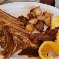 French Toast, 2 Eggs, Choice Of Bacon Or Sausage Served With Choice Of Side · 3 slices of French toast, 2 eggs, meat and side.
