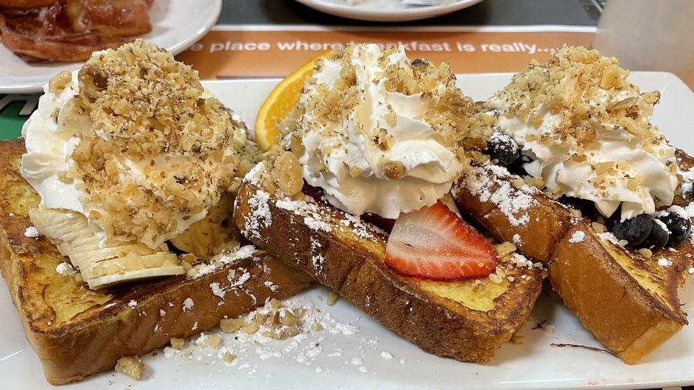 French Riviera · 3 pieces of French Toast overstuffed to the max with strawberries, bananas, blueberries, topped with whipped cream and nuts.