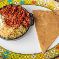 Meskel Kitfo · Delicious Ethiopian steak tartare, tender chopped beef seasoned with spiced butter and mitmi...