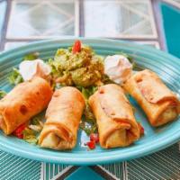 Chicken Baby Chimis · Lightly fried mini chimichangas filled with chicken and cheese. Served with guacamole and so...