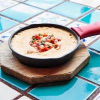 Queso · Our distinctive Mexican, melted cheese dip.