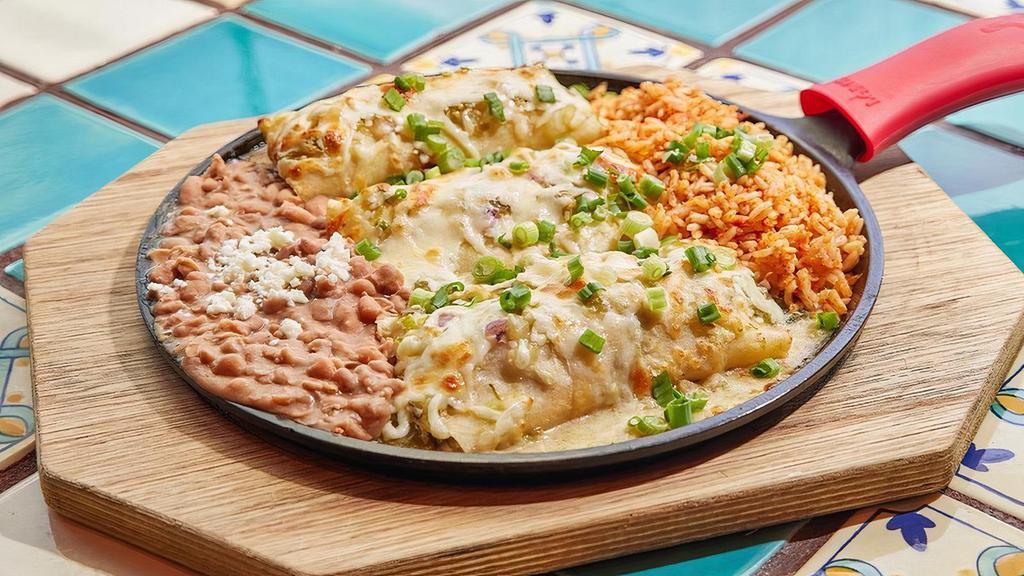Skillet Baked Enchiladas · One steak enchilada, one chicken enchilada and one stuffed with salsa fresca. Skillet baked with our house tomatillo sauce. Served with Mexican rice and beans.