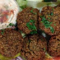 Falafel · Four pieces. Crispy chickpea patties seasoned with garlic, fresh herbs and onions with tahin...