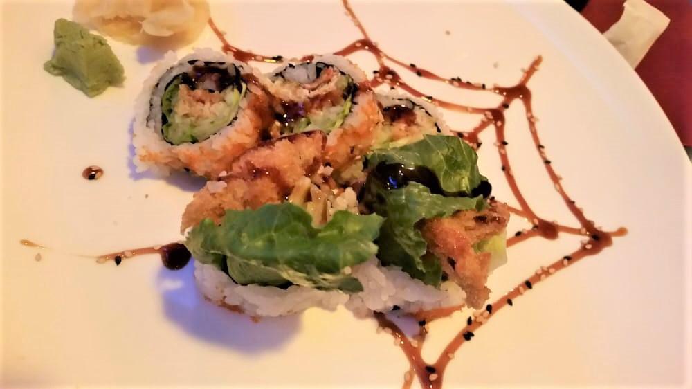 Spider Roll · Deep fried whole soft shell crab, cucumber, avocado, crab meat and tobiko outside.