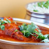 Chicken  Vindaloo  (G) · Boneless chicken cooked in a sharply special spiced sauce and potatoes