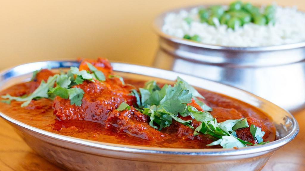 Chicken  Vindaloo  (G) · Boneless chicken cooked in a sharply special spiced sauce and potatoes