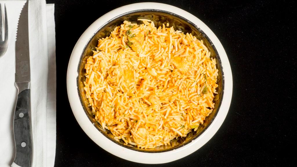 Chicken Biryani · Indian basmati rice cooked with boneless chicken, onions, fresh ginger, nuts, and delicate spices