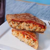 Shredded Chicken Wrap · Shredded chicken breast with carrots and parsley, cheese, and tomato on a wrap.