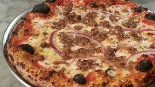 Salsiccia Pizza · Crushed tomato sauce, house sausage, house mozzarella, onion, garlic and basil.