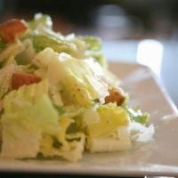 Caesar Salad · Crisp romaine lettuce tossed with our house made dressing and croutons then topped with Parm...