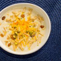 Badami Kheer · Chilled rice pudding flavored with cardamom and almond and garnished with pistachios.