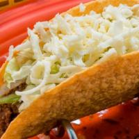Beef Taco - Hard · Crispy corn tortilla filled with ground beef,  lettuce and cheese.