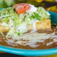 Chimichanga · Two soft or deep-fried flour tortillas filled with choice of ground beef, beef tips or pork ...
