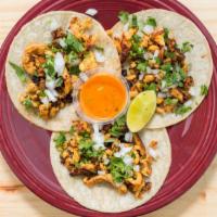 Vallarta Tacos · Three soft corn tortillas stuffed with grilled chicken cooked with Mexican sausage. Topped w...