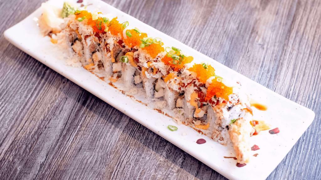 Kumagoro Roll · Shrimp Tempura, avocado, cream cheese, cucumber, crab meat, spicy mayo, unagi sauce, chili sauce, tobiko, onion, tempura flakes, eel.