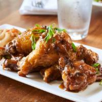 Crispy Chicken Wings · Sweet and Sour Soy Glaze, Spicy Slaw.