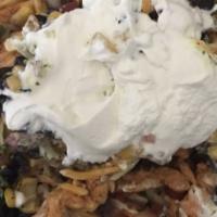 Taco Bowl · Choice of chicken or pork; rice, shredded cabbage, tomatoes, black bean and corn salsa, chee...