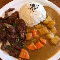 Beef Curry Rice Bowl · Pan-fried seasoned beef over jasmine rice served with Japanese curry topped with diced carro...