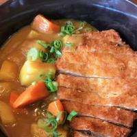 Pork Tonkatsu Curry Rice · Breaded deep-fried Pork cutlet over Jasmine rice served with Japanese curry, diced carrots, ...